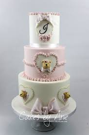 A chocolate or vanilla layer cake with white buttercream, topped with chocolate and vanilla tinys, decorated with baby decorations and white chocolate curls. Teddy Bear Baby Shower Cake Bear Baby Shower Cake Baby Shower Cakes Girl Baby Shower Cakes