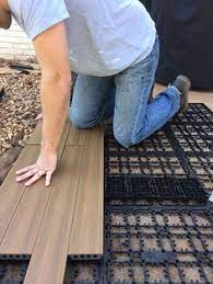 If you have a concrete patio or a wooden deck, you can enhance the floor area by covering it with modutile interlocking patio floor tiles. How To Lay Deck Flooring On A Concrete Patio Deck Flooring Patio Flooring Concrete Patio