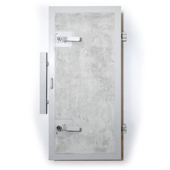 A reinforced steel blast door inside a Swiss underground civil defense shelter.