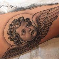 Angel Wings Heads Tattoo On Media Democracy Angel Tattoo Designs Baby Angel Tattoo Tattoos