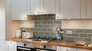 Sold unfinished and can be oiled or varnished onsite to desired appearance. White Shaker Kitchen With Wooden Worktops Burwash East Sussex