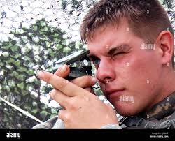 Soldier using compass Stock Photo