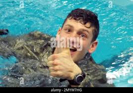 In this April 12, 2016 photo, ROTC cadet Curt Fedoush flashes a thumbs up  after completing an exercise in the pool at Norwich University in  Northfield, Vt. The exercise is part of the training undergone by ROTC  students at Norwich. On April 21 and 22 some ...
