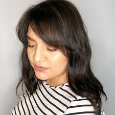 Whether you're going for short and punchy or long and blow dry your hair with a round brush to get this curled under look. 19 Flattering Medium Hairstyles For Round Faces In 2021