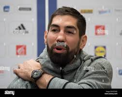 French handball player Nikola Karabatic (L), flanked by his lawyer Jean-Robert  Phung at the Montpellier courthouse for the trial of 16 people charged with  fraud over alleged match-fixing in Montpellier, France on