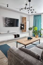 Secondly, i'm trying to pick out a coffee table. Modern Living Room Grey Sofa Carpet And Curtains Modern Floor Lamp Wooden Coffee Table White Cyan Colors Stock Photo Picture And Royalty Free Image Image 150365775