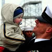 Chief Operations Specialist Brian Dahlheimer, greets his son during a  homecoming celebration for the amphibious assault ship USS Bataan (LHD 5)  at Naval Station Norfolk
