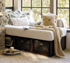 Daybed cushion features tufting and has piped edges; Stratton Storage Platform Daybed With Baskets Pottery Barn