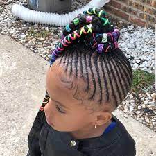 Little Black Girl With Her Hair Cornrowed Into A Ponytail Of Braids Adorned With Colorful Str Kids Braided Hairstyles Kids Hairstyles Little Black Girls Braids