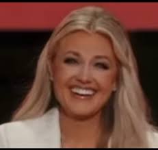 She is smiling bigger now than she did before he died