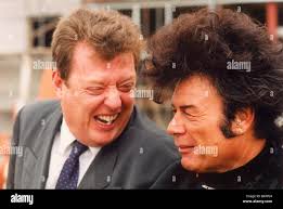 Former bassist of The Animals pop group Chas Chandler left pictured with  Gary Glitter Paul Gadd at the topping out ceremony of the Newcastle Arena  12 10 95 Stock Photo