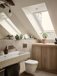 Bathroom with sloping ceiling and velux window and sink in foreground | andy spain photography. Small Attic Bathroom Sloped Ceiling Novocom Top