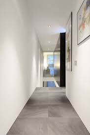 Black hexagon tiles transition into wood flooring. No Skirting Board Look Google Search Home House House Interior