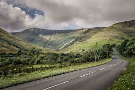 Countryside panorama with ruined castle on a hill at sunset countryside panorama with ruined castle on a hill. Visit Wales Launches Road Trips Highlighting Uniquely Welsh Experiences Recommend