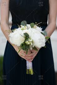 Scroll on down for some of the most creative bridesmaid outfit ideas navy blues and emerald greens are an unexpected combination that translate surprisingly well together. Bridesmaid In A Navy Blue Dress Holding A Bouquet Stock Photo Offset