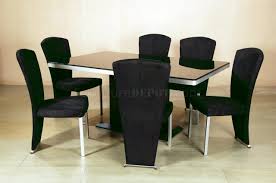 In a texturally rich dining room that combines contemporary and traditional styles, the natural wood table is surrounded by elegant wood frame chairs with dark leather upholstery. Black Glass Top Modern Elegant Dining Table W Optional Chairs