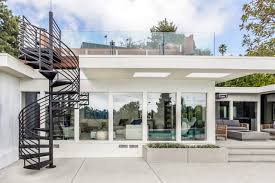 Although a rooftop deck and code compliant staircase were outside the scope and budget of the project, a roof access hatch and hidden staircase were included. Roof Deck Spiral Staircase Eden Builders