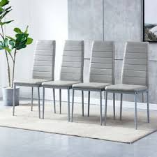 Dining room decor that features a narrow dining table with wooden construction and solid, decorative metal frame. Faux Leather Grey Dining Chairs For Sale Ebay