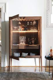 Boasting two doors with a gold chevron pattern, the top cupboard has a wine glass holder and four shelves. The Latest Drinks Cabinets To Get Your Party Off The Ground Livingetc