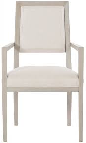 Subdued ivory upholstery set against sculptural hardwood frames in gleaming gold leaf. Chairs Bernhardt