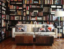 Slightly curved shelves on the wall look beautiful and because of this design books do not fall. A House Without Books Is Like A Room Cozy Home Library Home Library Design Home Libraries