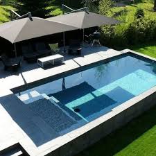 With The Summer Swimming Season Just Around The Corner Now S The Perfect Time To Renovate That Backyard An Amazing Swimming Pools Backyard Pool Pool Umbrellas