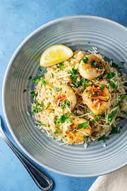 When the oil is hot, sprinkle the scallops with salt and pepper and brown well on both sides, about 2. Lemon Butter Scallops Over Parmesan Risotto Recipe Kitchen Swagger