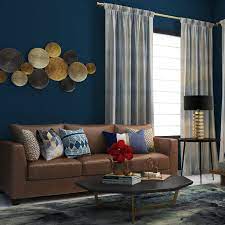 A Navy Blue Wall Matched With A Classic Brown Sofa Brown Living Room Decor Blue Walls Living Room Blue Living Room