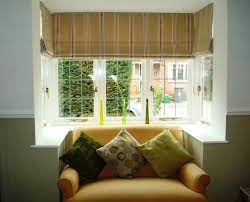 Square Bay Windows Dressed With Roman Blinds A Cold Little Corner Became Rathe Bay Window Curtains Living Room Window Curtains Living Room Bay Window Design