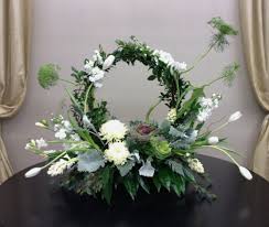 White And Green Floral Arrangement With Fresh Greenery Wreath Tulips Hyaci Church Flower Arrangements White Flower Arrangements Beautiful Flower Arrangements