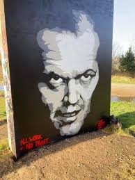 Graffiti murals under a bridge.