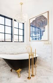 Black And Gold Art Deco Bathroom Chic Contemporary Bathroom Is Illuminated By An Art Deco Glass Fringe Chandelier Hung Over A Gold And Black Vintage Bathtub Vintage Tub Contemporary Bathrooms
