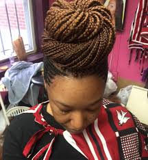 Close up profile of asian/indian young woman braiding hair. Laura S Hair Braiding Hair Salon In Washington Dc 20011