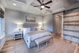 Huge beach style master medium tone wood floor and brown floor bedroom photo in new york with white walls, a standard fireplace and a stone fireplace i like. Beach Style Bedroom Beach Style Bedroom Miami Houzz