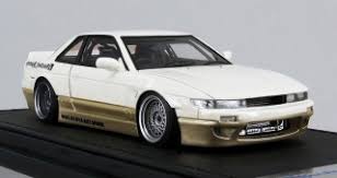 Blue flames on front fenders & hood, pearl white interior, unpainted thailand base, w/bw's. Rocket Bunny S13 V1 White Gold Diecast Car Hobbysearch Diecast Car Store