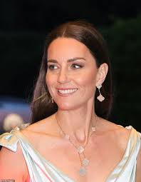 Duchess of Cambridge looks a world away from this afternoon's wet regatta  as she dazzles in gown