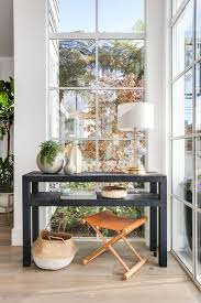 Raffia Console Table A Pair Of Black Raffia Console Tables Add Character While Not Obscuring The Windows In This Foyer Decor Black Console Table Foyer Design