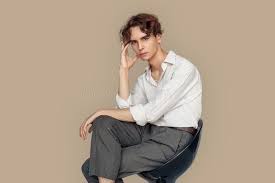 Check spelling or type a new query. Freestyle Man In Formal Wear Sitting On Chair On Gray Crossed Legs Touching Head Pensive Pensive Stock Image Image Of Emotion Grey 169801153