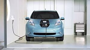 Blue Nissan Leaf Electric Car Charging At Home Nissan Leaf Nissan Leaf Charging Electric Car Charging