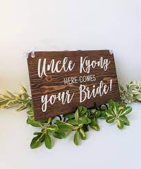 Let your ring bearer announce your arrival with this white here comes the bride sign. Uncle Here Comes Your Bride Sign Ring Bearer Sign Wood Flower Girl Sign Personalized Here Comes The Bride Wedding Sign