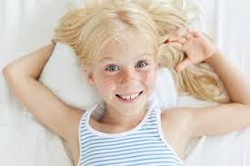 Beautiful baby girl with blonde hair | beautiful baby girl. Free Photo Cute Little Female Child With Blonde Hair Blue Eyes And Freckled Face Smiling Joyfully While Relaxing On Bed Lying On White Pillow