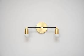This stylish candlestick on the wall is a beautiful combination of steel structure in shades of bronze or old gold and glass candlestick. Stunning 2 Bulb Wall Sconce Available In Brass Black And Brass Mix Polished Nickel And Powder Bathroom Wall Sconces Candle Wall Sconces Wall Sconces Bedroom