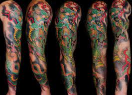 Full sleeve dragon tattoo with guitar: Japanese Dragon Sleeve Tattoo By Skull And Sword
