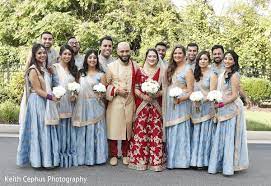 Indian Newlyweds Posing With Bridesmaids And Groomsmen Indian Wedding Bridesmaids Bridesmaids And Groomsmen Indian Bridal Party
