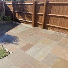 Lower the first paving slab onto the concrete mix. Raj Green Indian Sandstone Paving Slabs Patio Stones Nustone Sandstone Paving Patio Stones Sandstone Paving Slabs