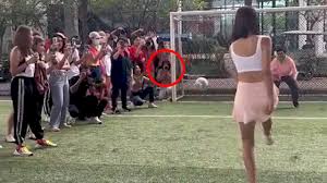 Beauty queen misses penalty and injures photographer crouching beside goal