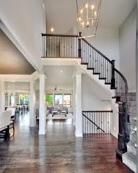 2 Story Entry Way New Home Interior Design Open Floor Plan Light Fixtures Spindles On Curved Staircase By Bic Home Builders New Home Builders House Design