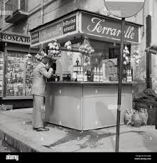 1950S, Historical, Naples, Italy, A Man Drinking At A Street Kiosk Of  Ferrarelle, An Italian Sparking Mineral Water. The Water From Val D'Assano,  Naples Has A Unqiue Flavour Coming As It Does