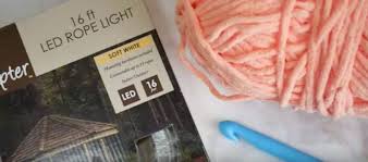 Lady starts crocheting over a LED lights strand. Try not to adore the result