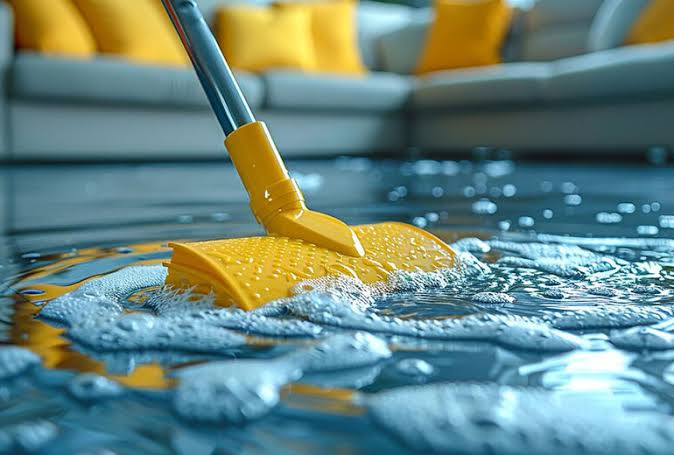 A professional cleaner using non-toxic fluid to clean a floor